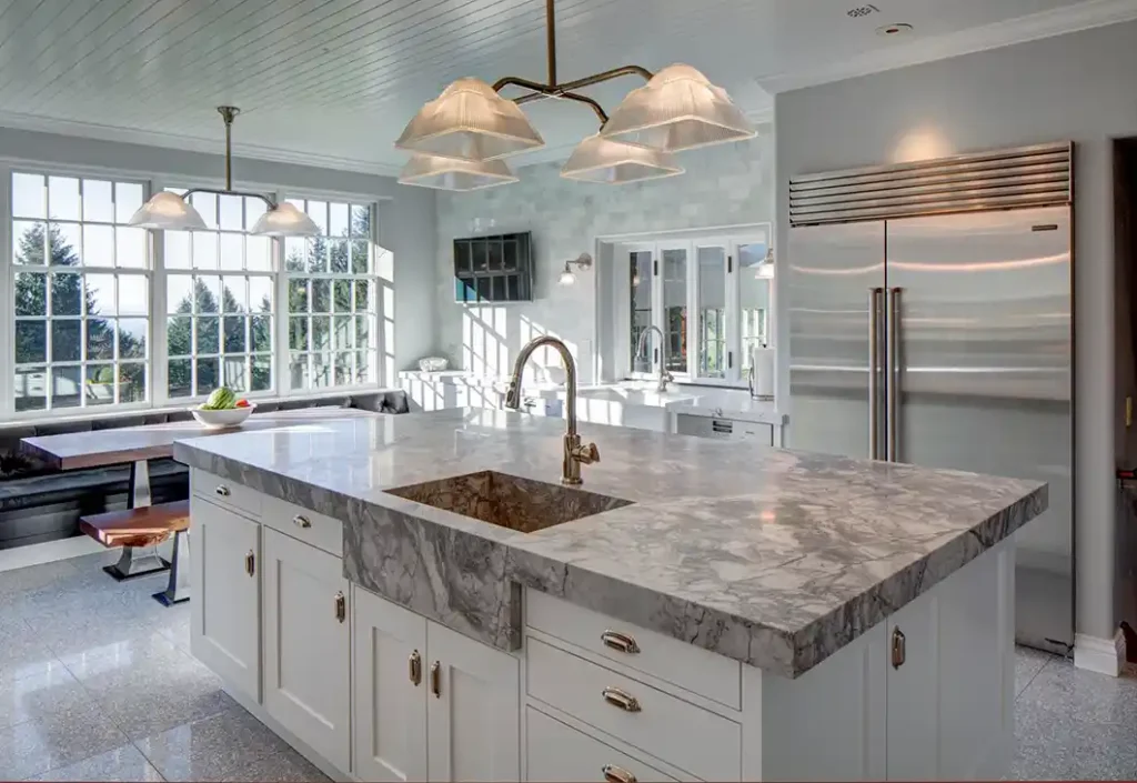 Person applying sealant to a marble countertop using a paintbrush.